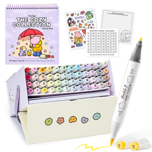 Kit Ohuhu x Coco Wyo Cozy Mood : boîte présentoir ouverte avec 48 marqueurs à alcool pastel, livre de coloriage The Cozy Collection, stickers et nuancier